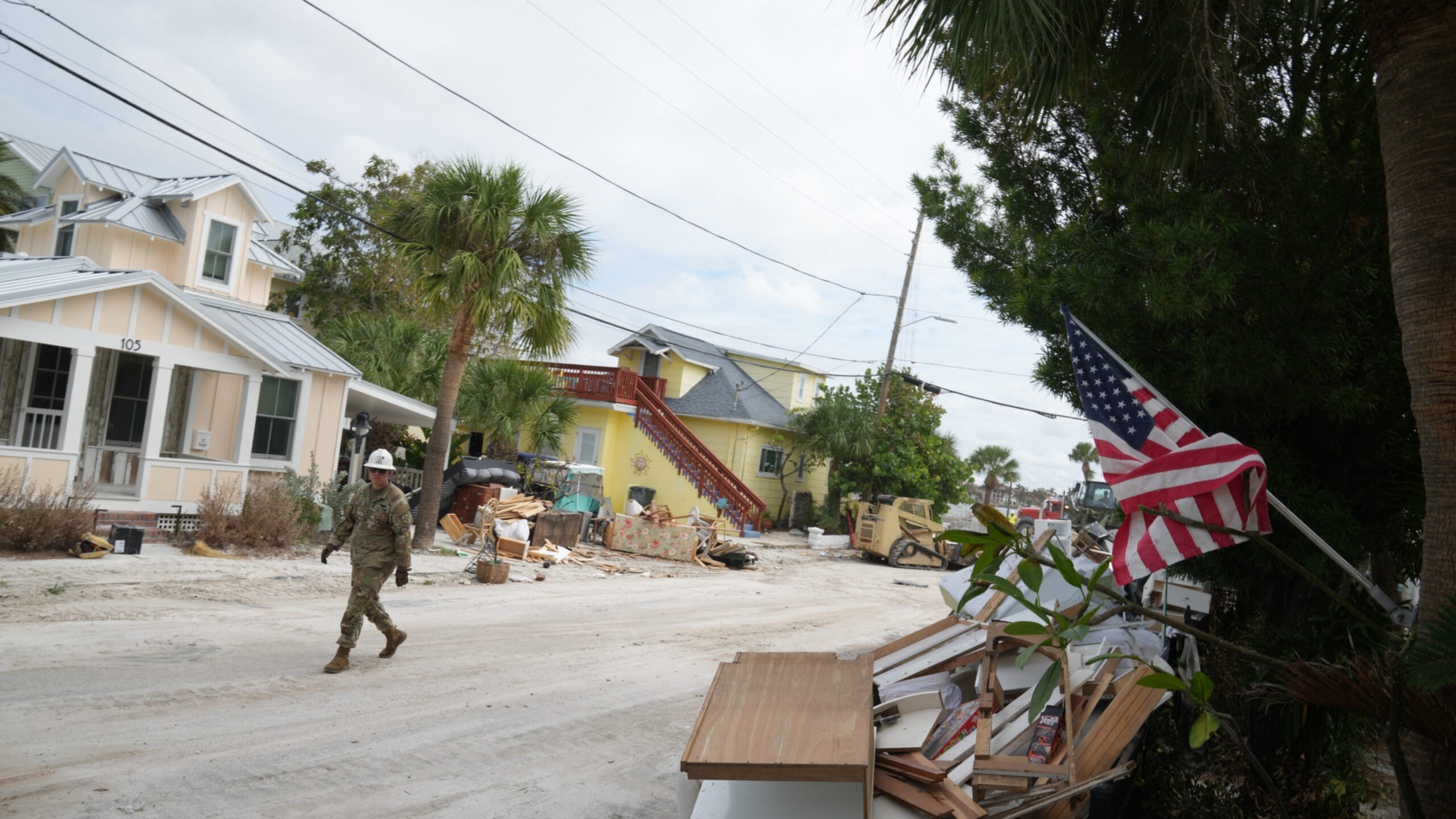 A member of the Florida Army National Guard during debris removal in the Pass-A-Grille section of St. Petersburg ahead of Hurricane Milton's expected landfall in the middle of this week on October 7, 2024 in Florida. - Florida's governor has declared a state of emergency on Saturday as forecasters warned that Hurricane Milton is expected to make landfall later this week. (Photo by Bryan R. SMITH / AFP)