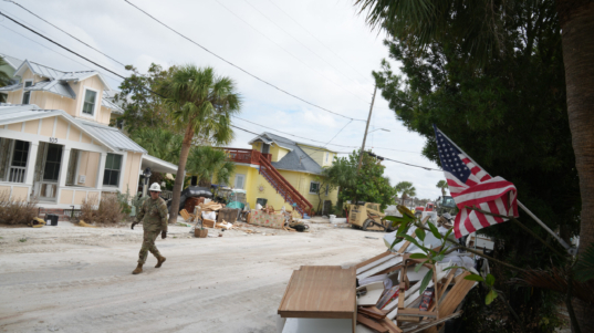 A member of the Florida Army National Guard during debris removal in the Pass-A-Grille section of St. Petersburg ahead of Hurricane Milton's expected landfall in the middle of this week on October 7, 2024 in Florida. - Florida's governor has declared a state of emergency on Saturday as forecasters warned that Hurricane Milton is expected to make landfall later this week. (Photo by Bryan R. SMITH / AFP)