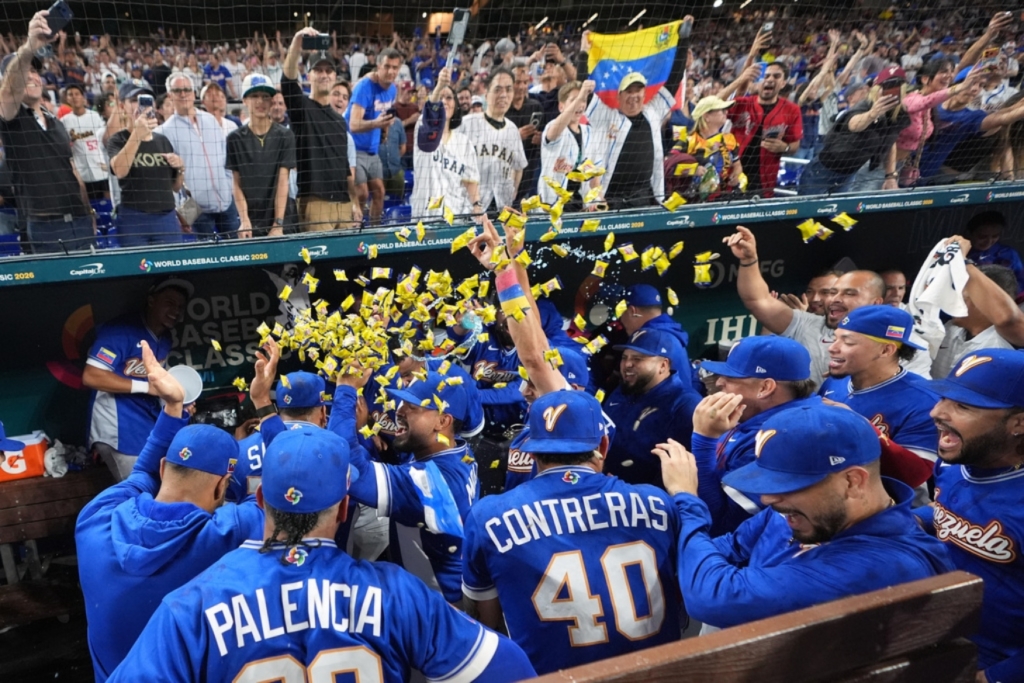 Venezuela team celebrate their victory over Japan after a World Baseball Classic quarterfinal game, Saturday, March 14, 2026, in Miami. (AP Photo/Lynne Sladky)